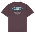 A dark plum purple short-sleeve t-shirt with a graphic on the back. The graphic features an oval logo with a mountain background and the word 'ARBOR' in white, along with smaller white text reading 'VENICE CA' and 'WINDFULLY DRAFTER ENBOARDERS & SKATEBOARDS FOR GOOD 7:42$'.