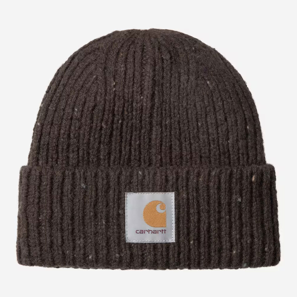 A dark brown ribbed knit beanie hat with a white square Carhartt logo patch on the front cuff, shown against a light gray background.