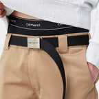 Person wearing Carhartt pants with a black belt and white shirt.