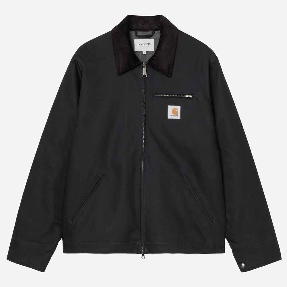 A navy Carhartt jacket with a dark corduroy collar, front zipper, zippered chest pocket, and a signature Carhartt logo patch on the left chest, shown against a light gray background.