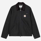 A navy Carhartt jacket with a dark corduroy collar, front zipper, zippered chest pocket, and a signature Carhartt logo patch on the left chest, shown against a light gray background.