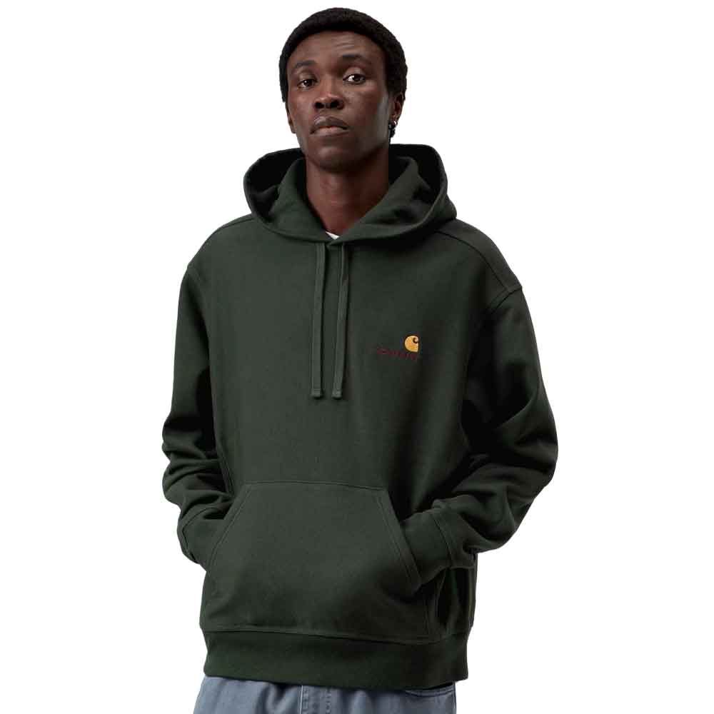 A man wearing a dark forest green Carhartt hoodie with a small embroidered Carhartt logo on the left chest, set against a plain white background.