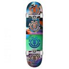 A full-length skateboard featuring a colourful abstract graphic design with three stacked circular Element logo graphics in orange, silver, and blue tones.