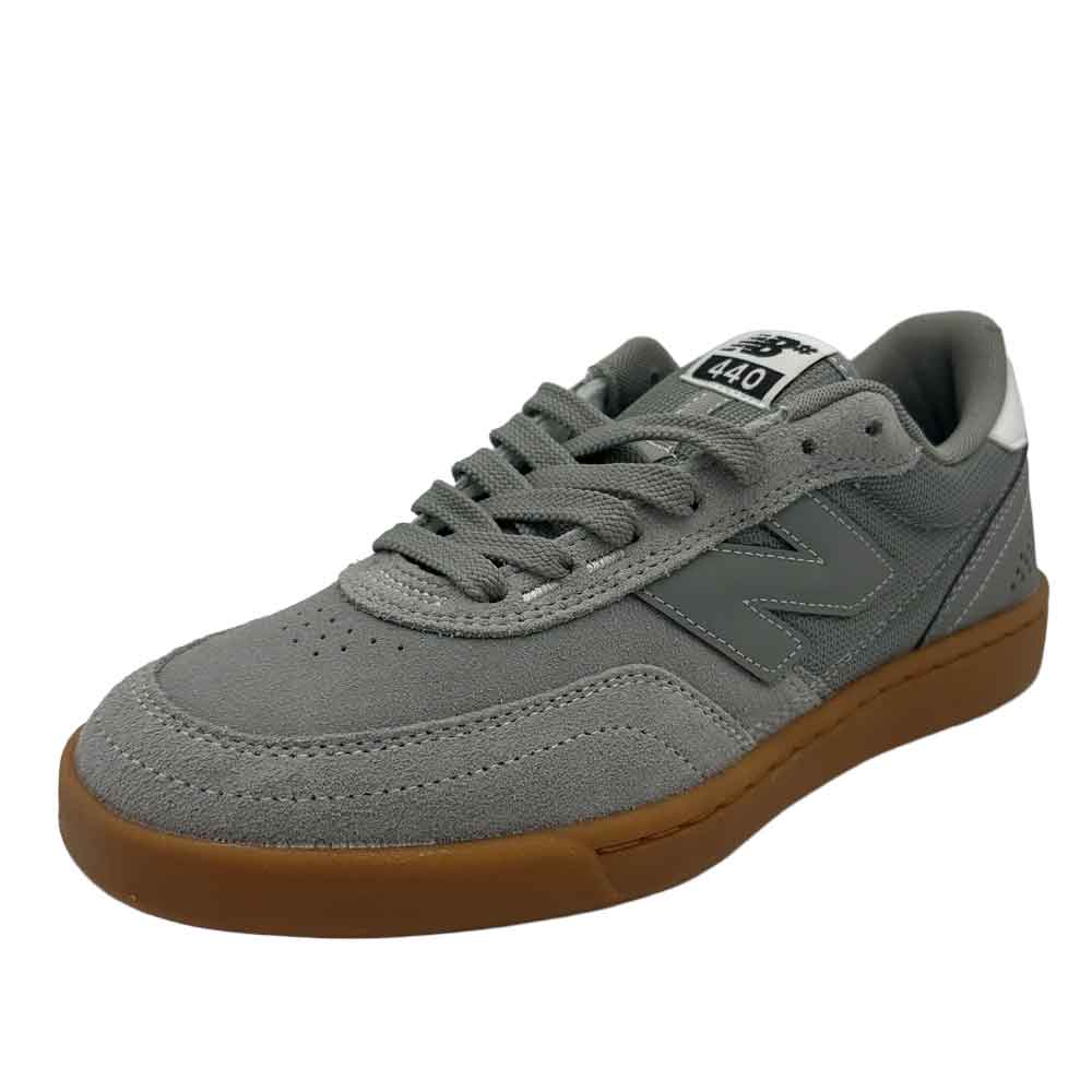 A gray New Balance 480 sneaker with a brown gum sole, shown from a three-quarters angle on a white background.