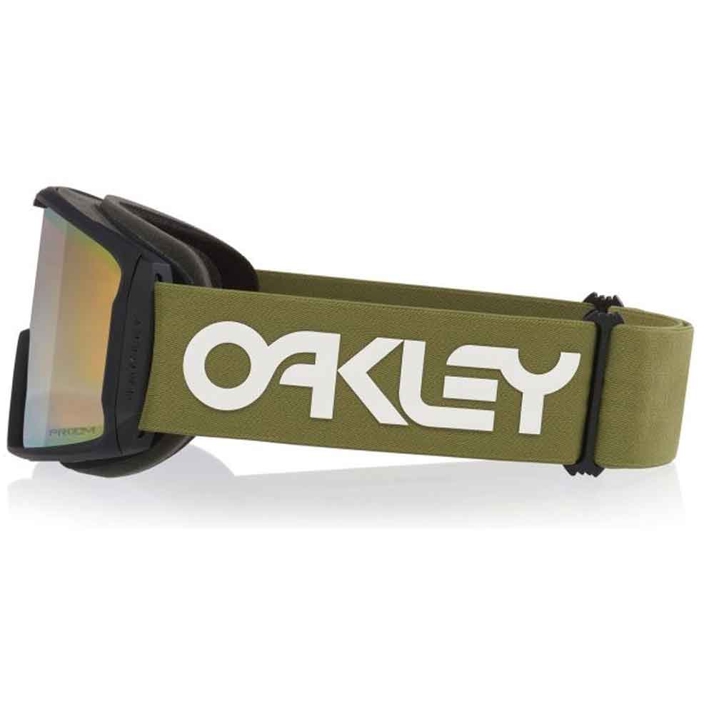 Oakley snow goggles with an olive green strap featuring a large white Oakley logo, a black frame, and a reflective gold-tinted lens.