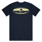 A navy blue short-sleeve t-shirt with a vintage-style cream graphic on the chest that reads 'OCEAN SPORTS SURF SHOP BRIGHTON BOARD RIDERS' with a surfer illustration.