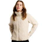 A woman modeling a cream-colored, sherpa fleece zip-up jacket against a plain white background.