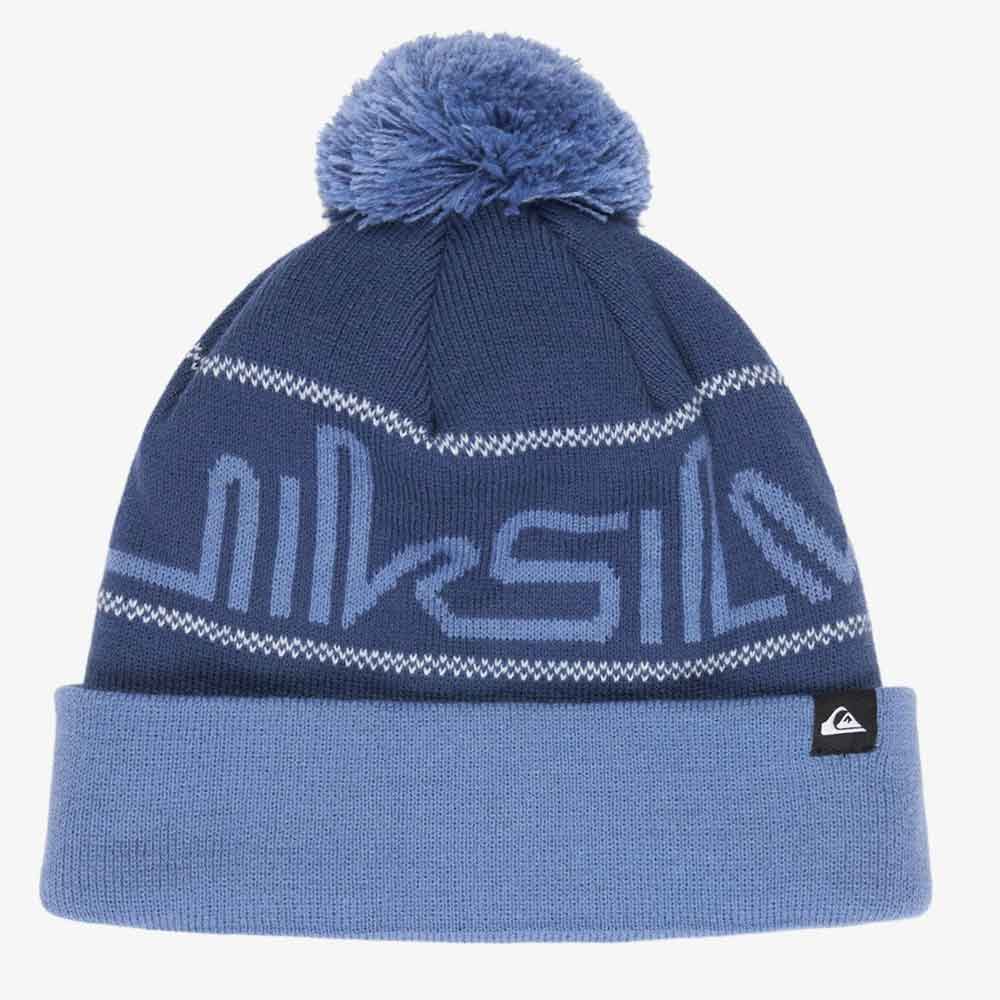 A navy blue knit beanie with a light blue pom-pom, featuring a large light blue 'quiksilver' logo across the front, white decorative stripes, and a light blue folded cuff with a small black brand tag.