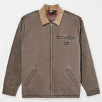 A brown zip-up work jacket with a tan corduroy collar, featuring a chest pocket with a small quiksilver logo patch, two front hand pockets, and a zippered front closure, shown flat on a light gray background.