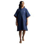 A woman modeling a navy blue hooded poncho with orange lining details on the hood and sleeve cuffs, set against a plain white background.