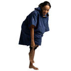 A woman wearing a navy blue hooded towel top or poncho-style garment, shown from the back against a plain white background.