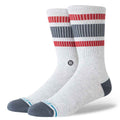 A pair of Stance crew socks in heather white, featuring red and dark gray horizontal stripes on the upper leg, a dark gray heel and toe, and a light blue Stance logo on the toes.