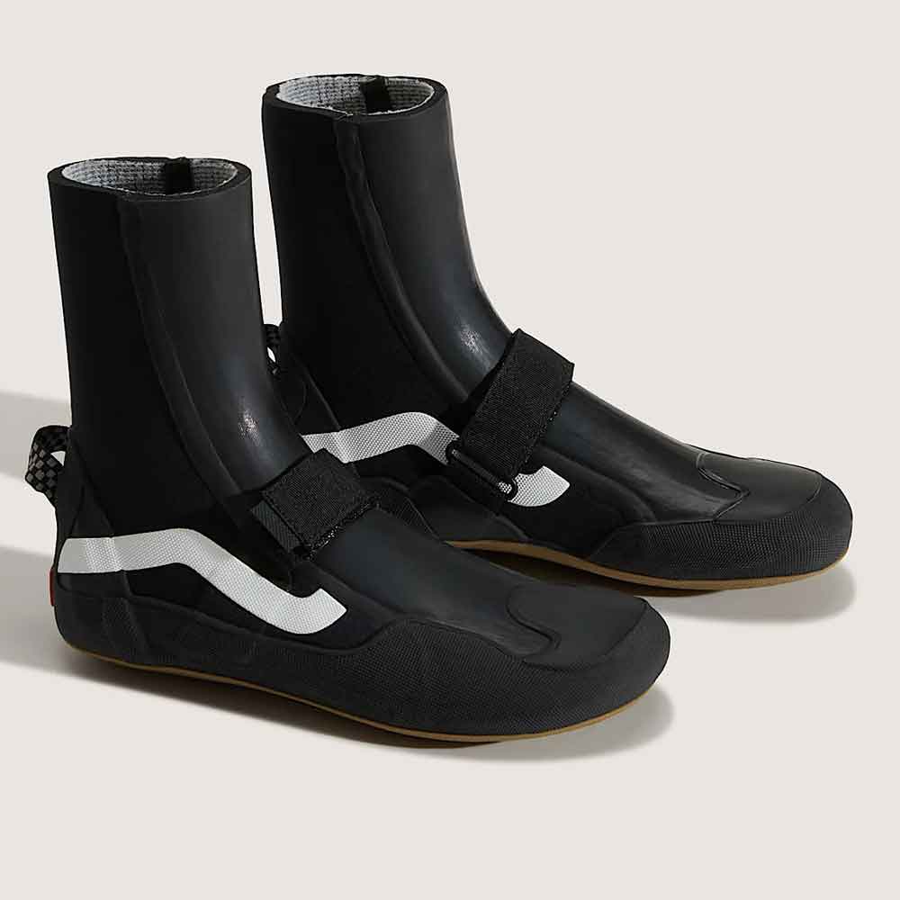 A pair of black wetsuit boots with white side stripes and hook-and-loop strap closures, displayed on a light beige background.