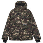 A hooded camouflage jacket with a green, brown, and tan woodland camo pattern, featuring a black zipper, front pockets, and a small black brand patch on the chest.