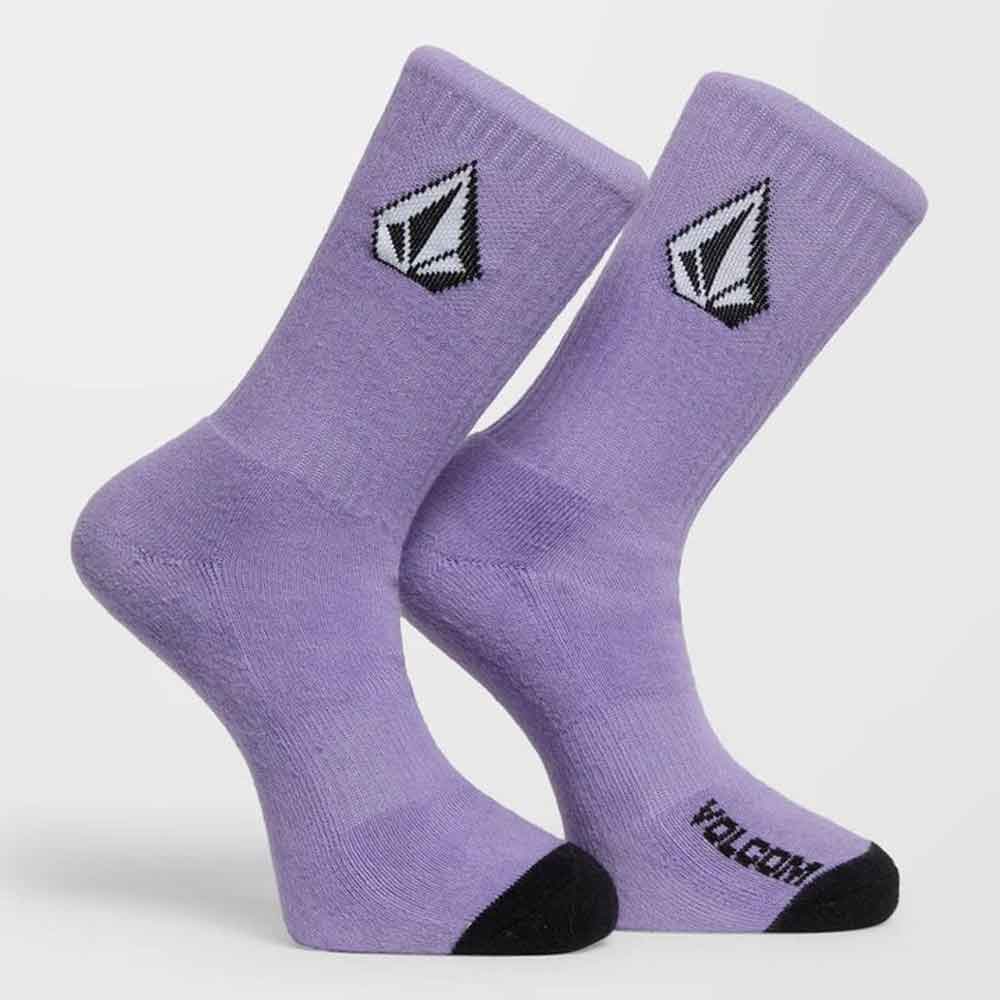 A pair of Volcom crew socks in lavender purple, featuring the brand's signature diamond logo on the upper calf and a black toe cap.