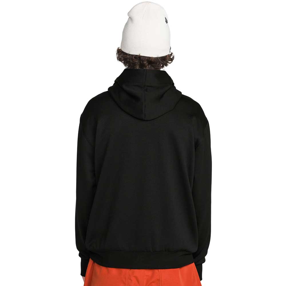A person shown from the back wearing a black pullover hoodie, a white beanie, and bright orange pants 