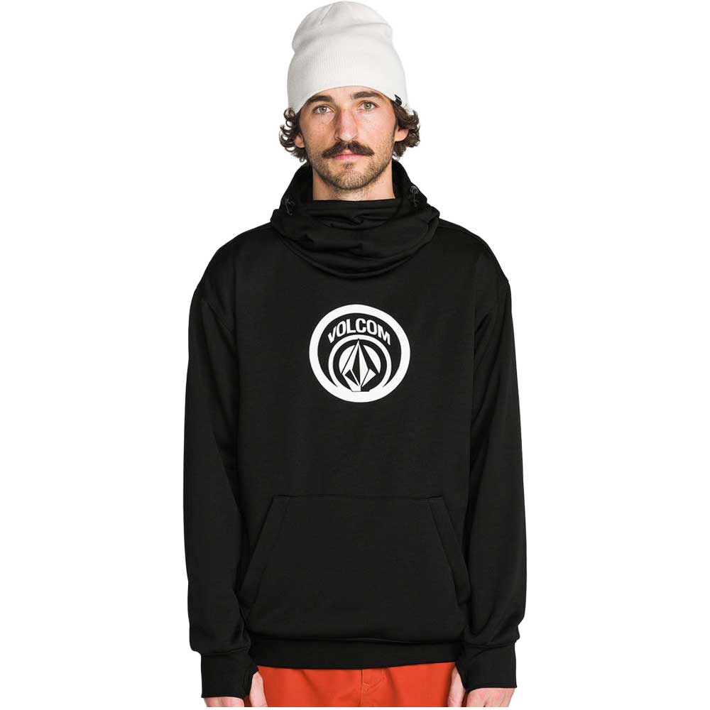 A person wearing a black pullover hoodie, a white beanie, and bright orange pants 