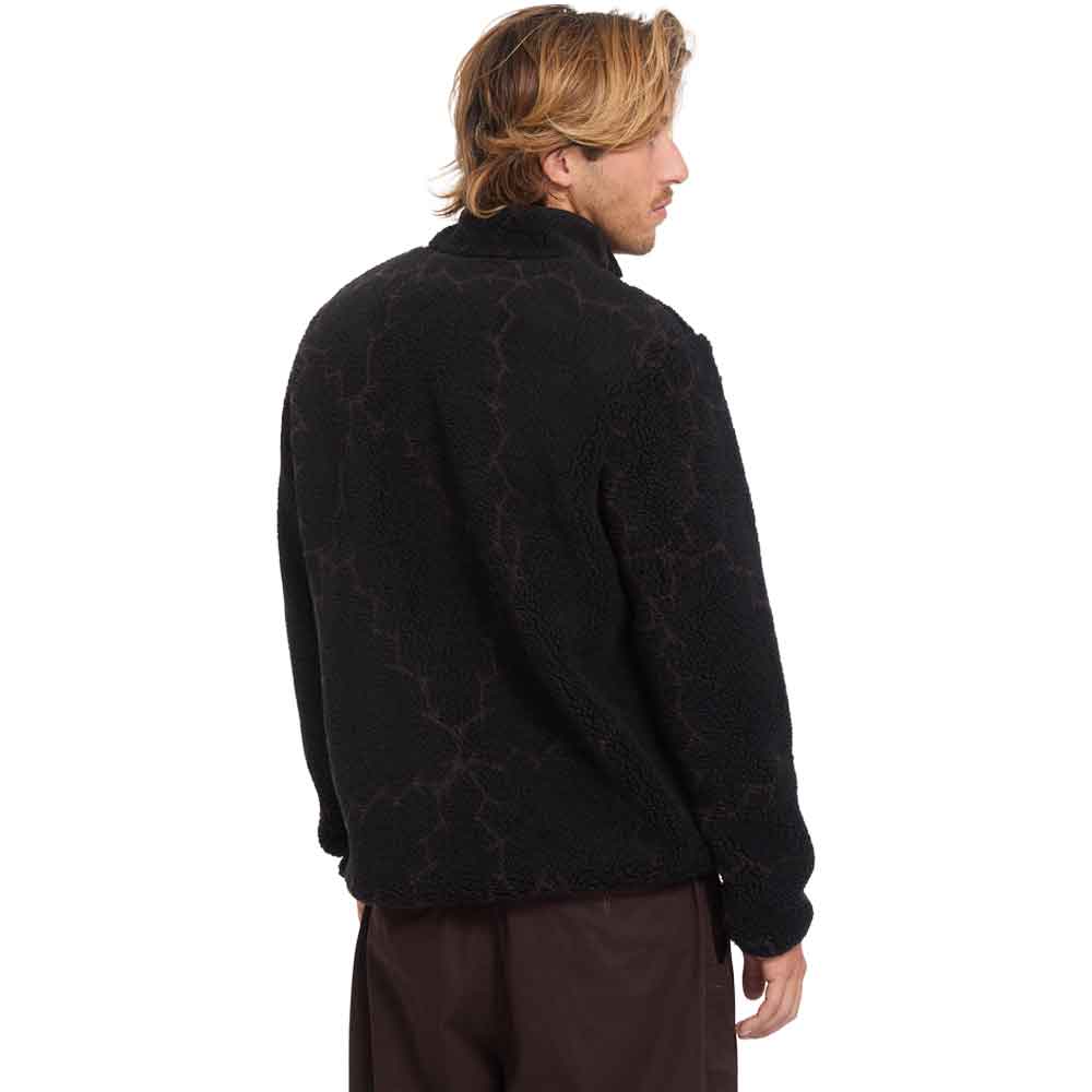 A man wearing a black textured fleece jacket with a subtle dark red branch-like pattern, shown from the back against a plain white background.