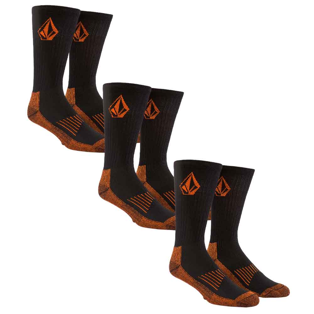 three pairs of Volcom crew socks in black with orange logo and textured orange toe, heel, and sole details, arranged on a plain white background.